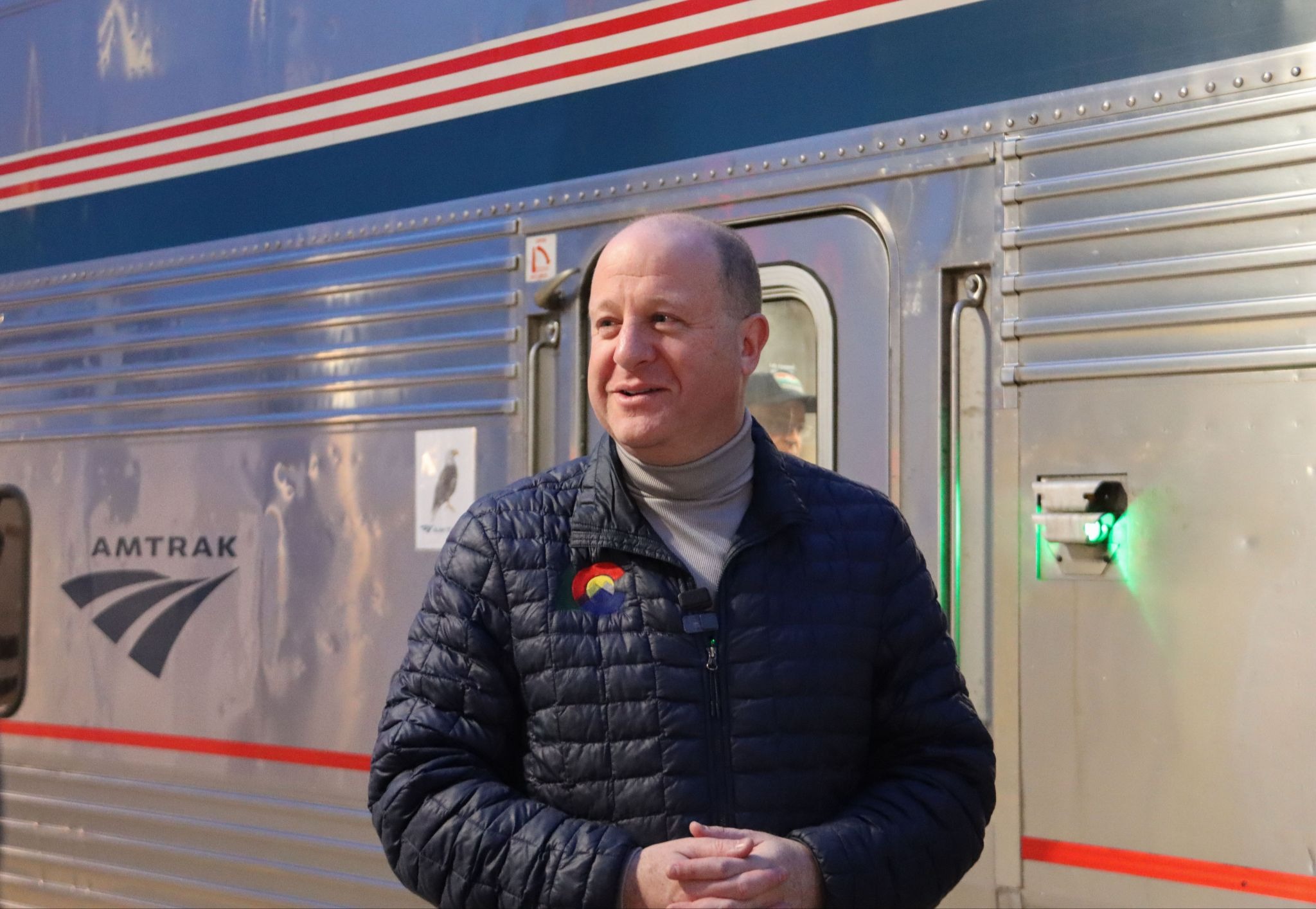 Governor Polis Smiles on Platform for Winter Park Express Train